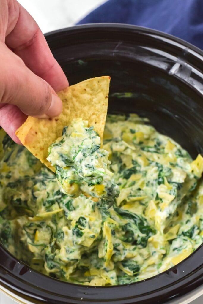 Spinach artichoke dip in a crockpot.