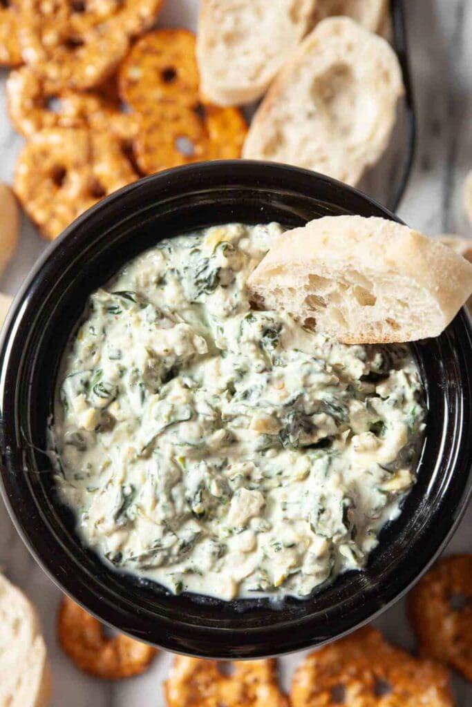 Crockpot spinach artichoke dip in a serving bowl.