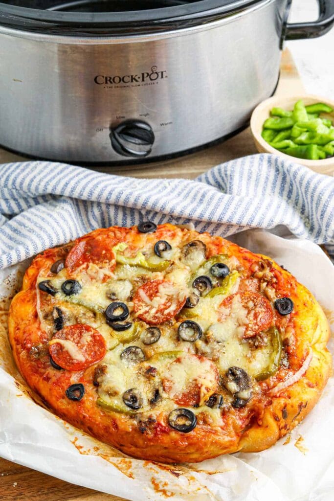 Crockpot supreme pizza on parchment paper.