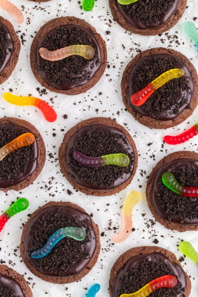 Dirt and worm cake mix cookies topped with gummy worms and chocolate crumbs.