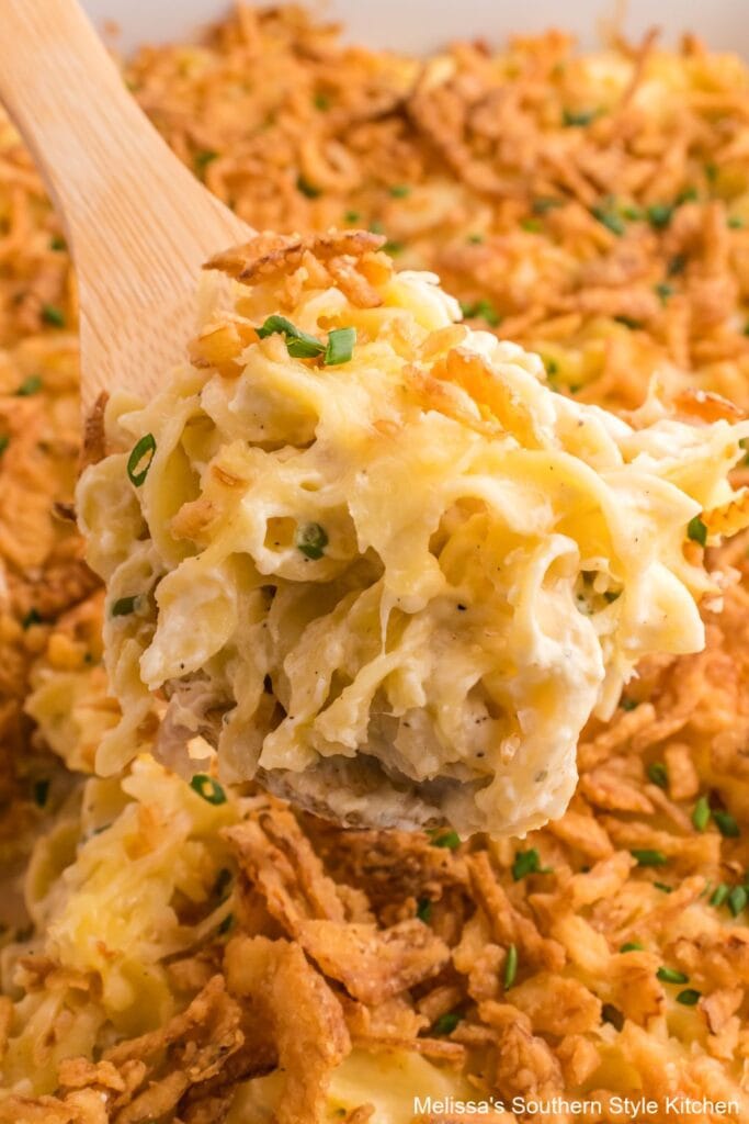 French onion chicken noodle casserole on a wooden spoon.