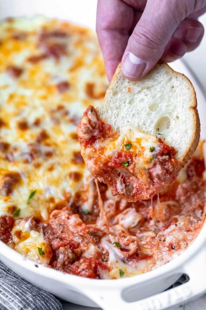 Lasagna dip with melted cheese in a baking dish.