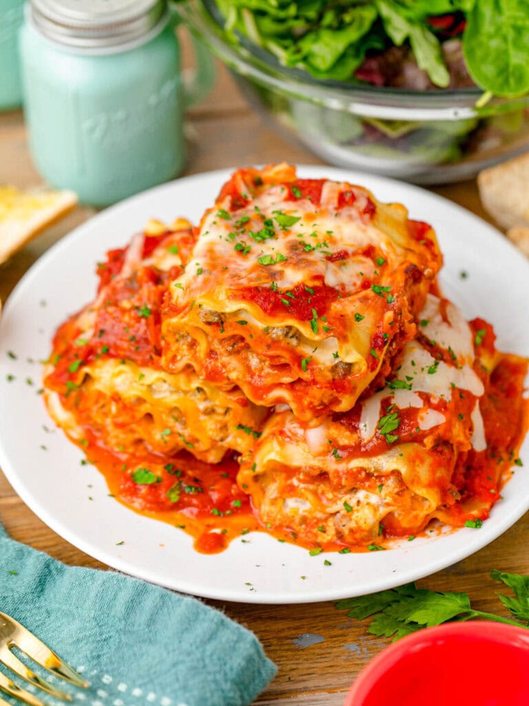 Lasagna roll ups with tomato sauce on a plate.
