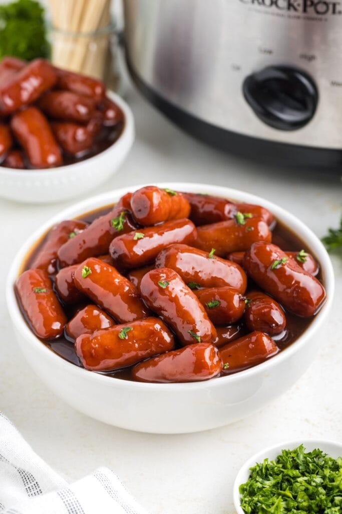 Little smokies with grape jelly in a bowl.