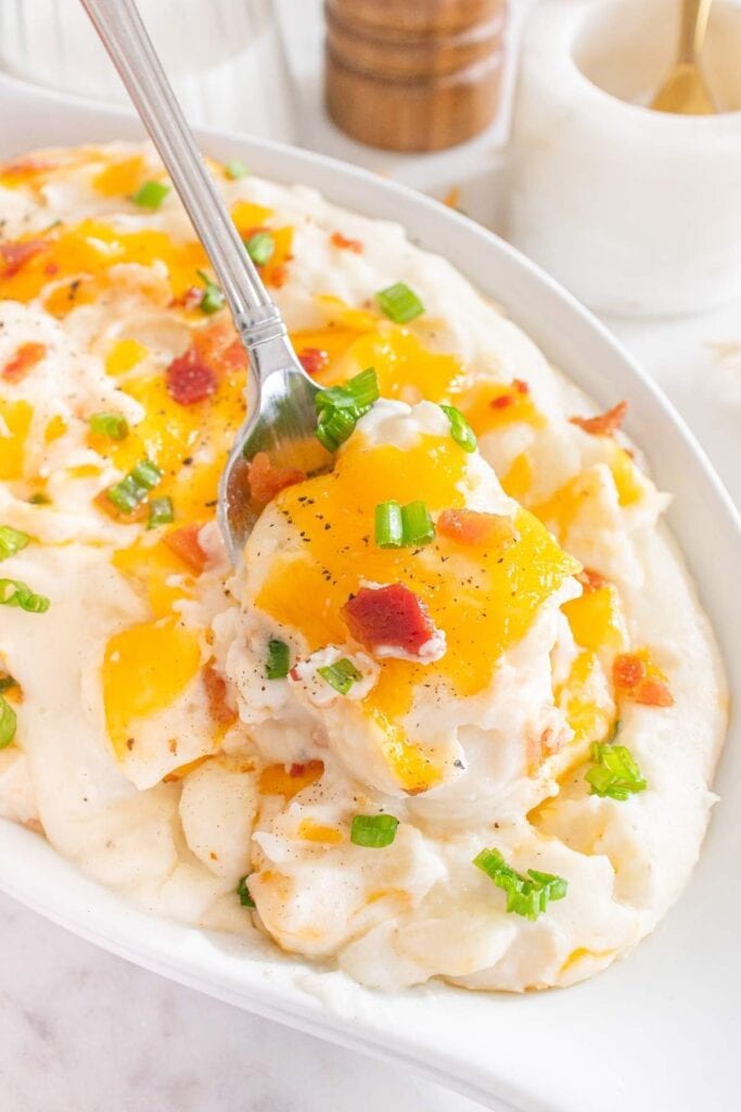 Loaded mashed potato casserole in a serving dish.