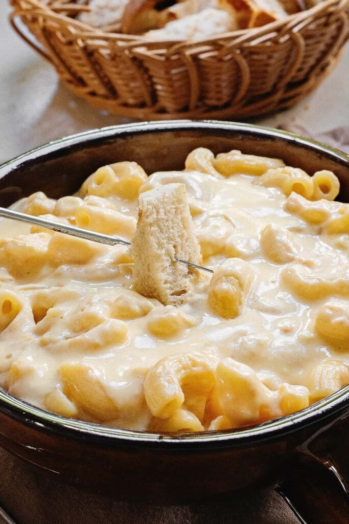 Macaroni and cheese fondue in a bowl.