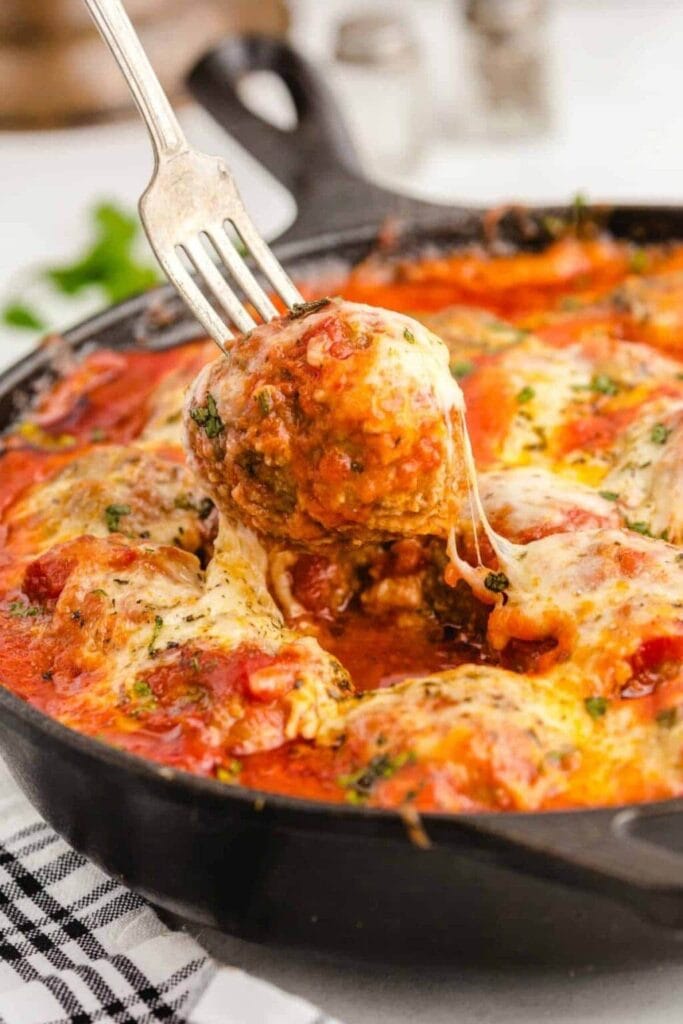 Meatball Parmesan in a skillet.