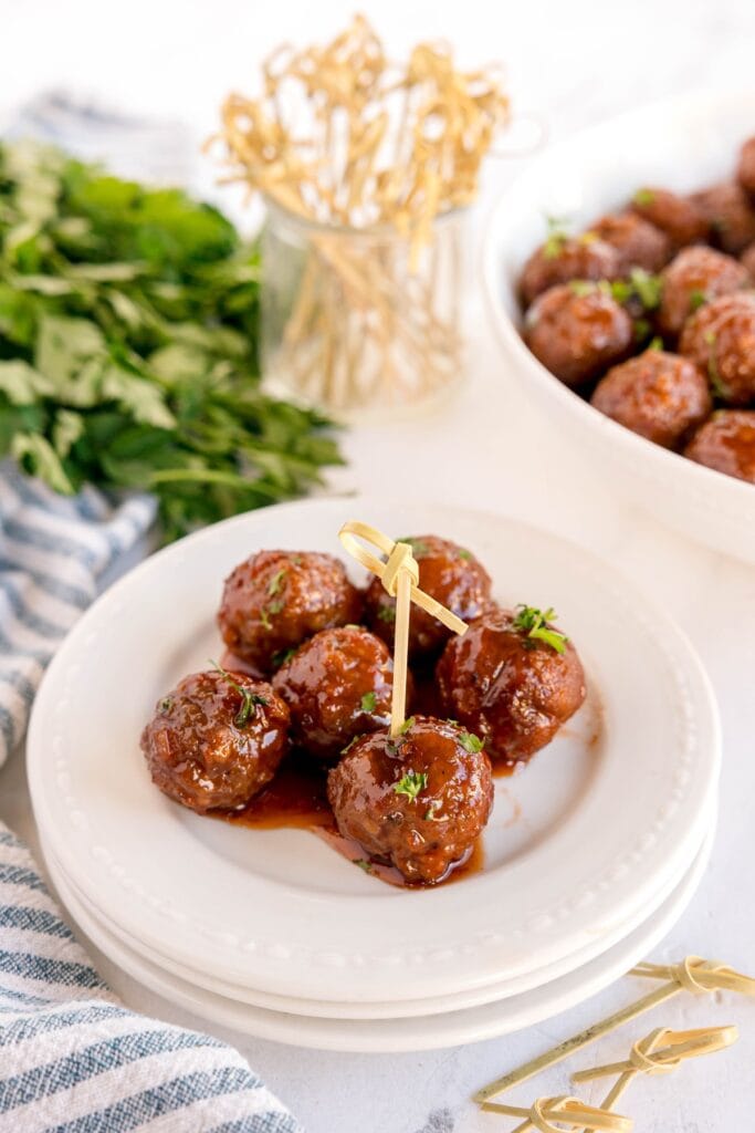 Meatballs with grape jelly and chili sauce on a plate.