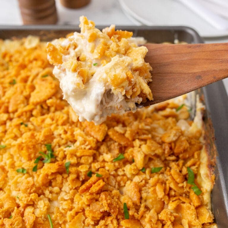Million dollar chicken casserole on a wooden spoon.