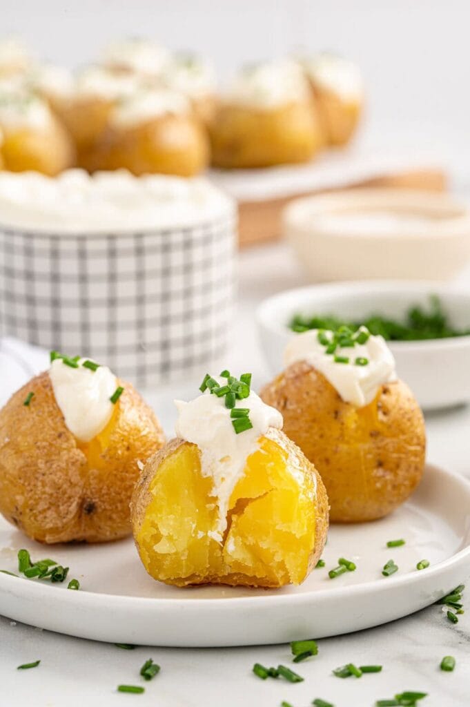Mini baked potatoes on a plate.