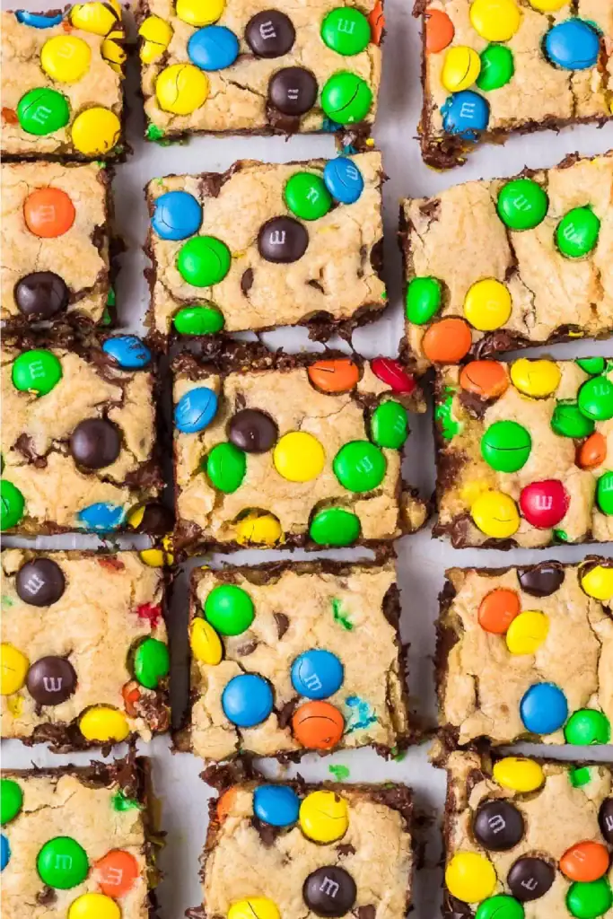 M&M cookie bars filled with colorful M&M candies and chocolate chips.
