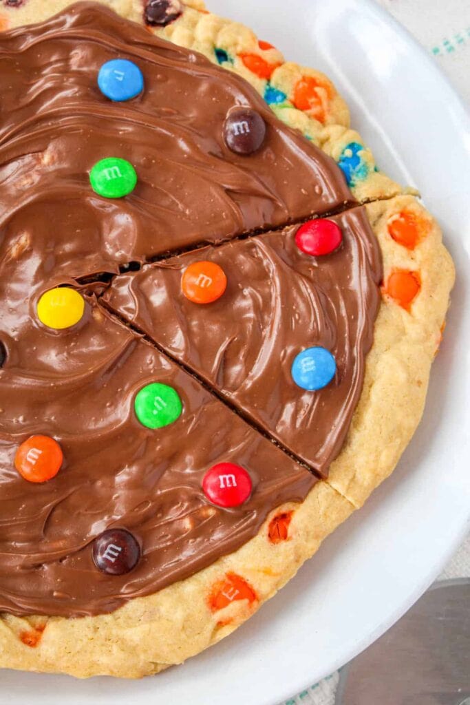 M&M cookie pizza on a plate.