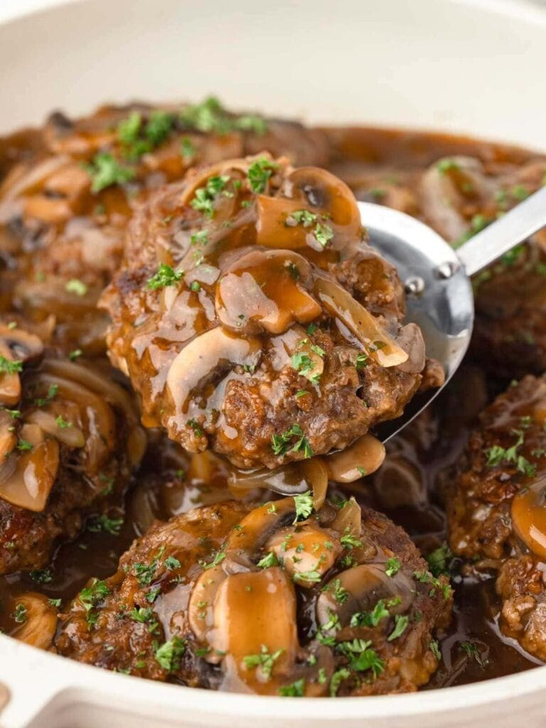 Old fashioned Salisbury steak in a skillet.