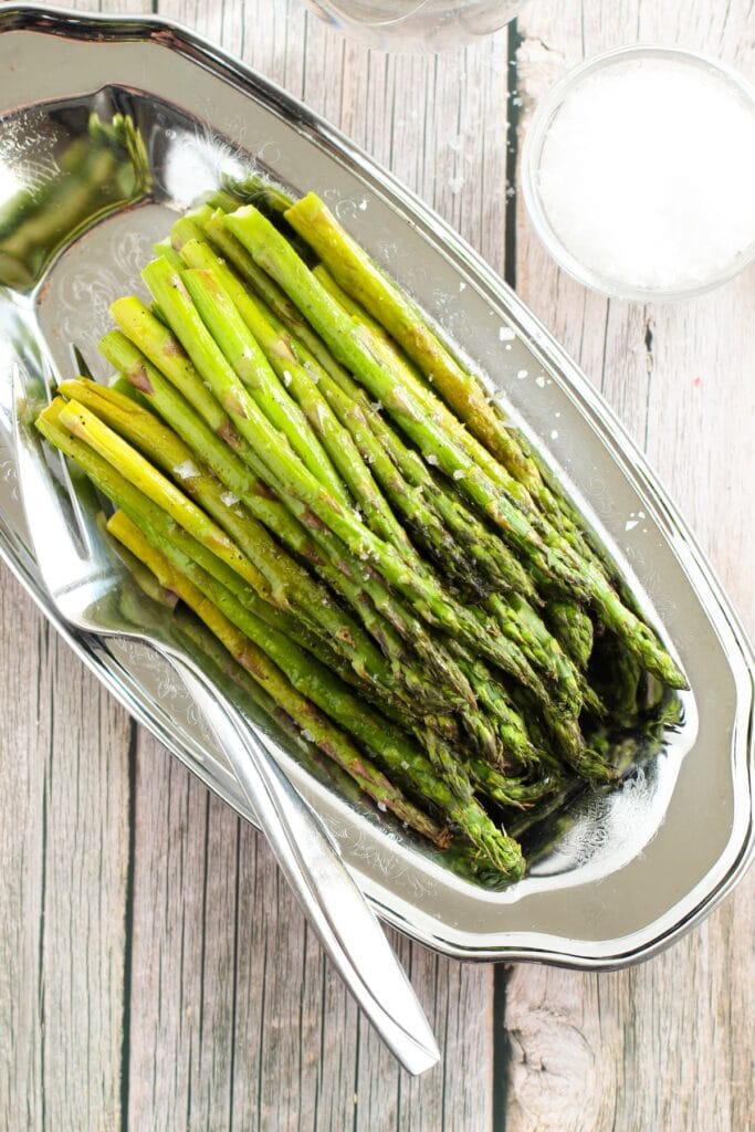 Oven roasted asparagus in a serving dish.