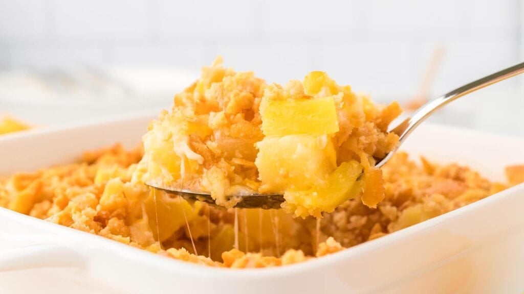 Close-up of pineapple casserole on a spoon.