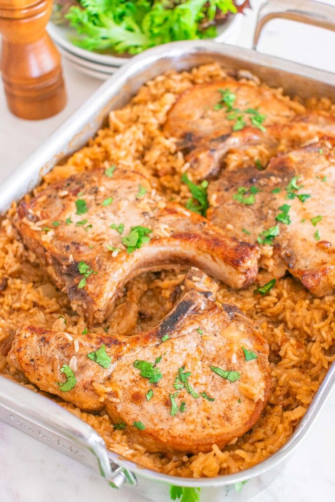 Pork chop and rice casserole in a baking dish.
