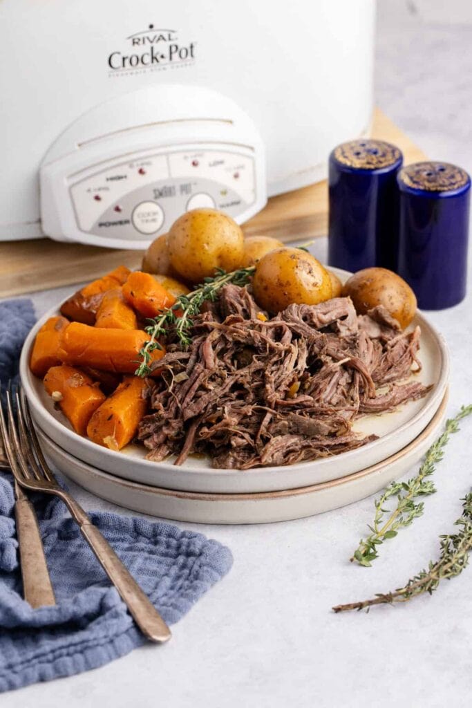 Slow cooker pot roast with vegetables on a plate.