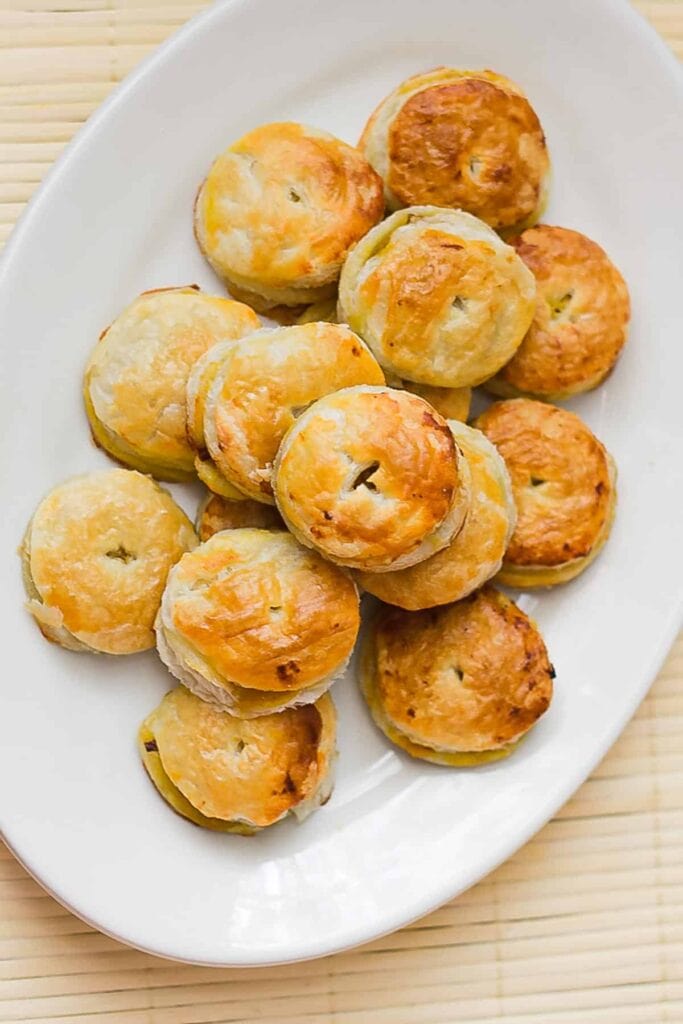 Pumpkin and caramelized onion puff pastry pockets on a plate.