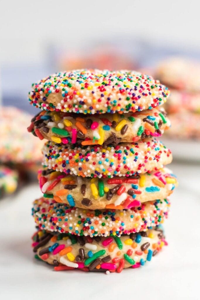 Stack of rainbow sprinkle cookies.