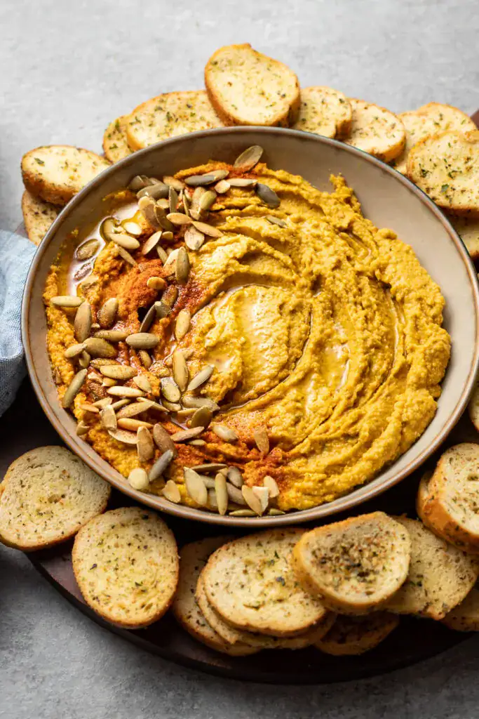 Roasted garlic sage pumpkin hummus in a bowl.