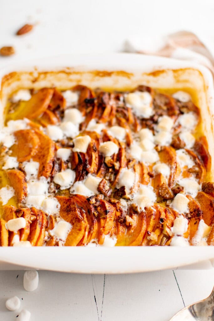 Scalloped sweet potatoes in a baking dish.