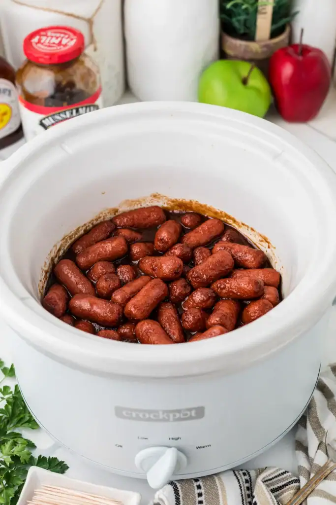 Apple butter little smokies in a slow cooker.