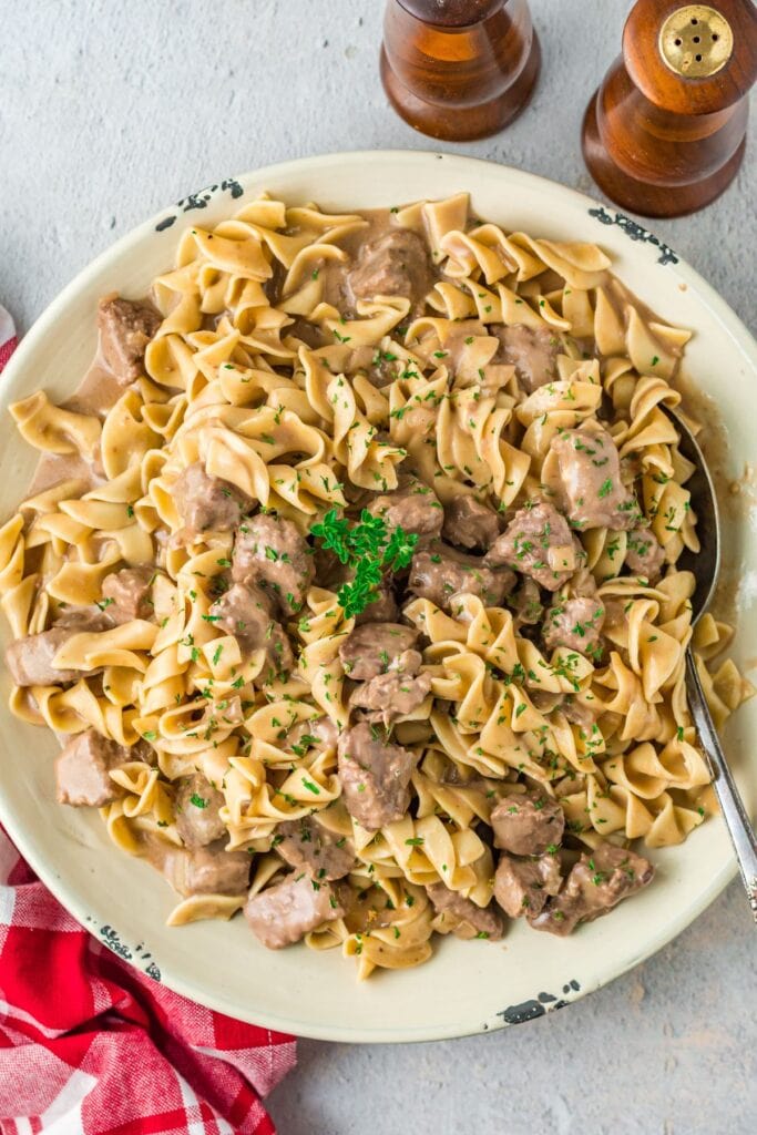 Slow cooker beef and noodles with mushrooms in a bowl.