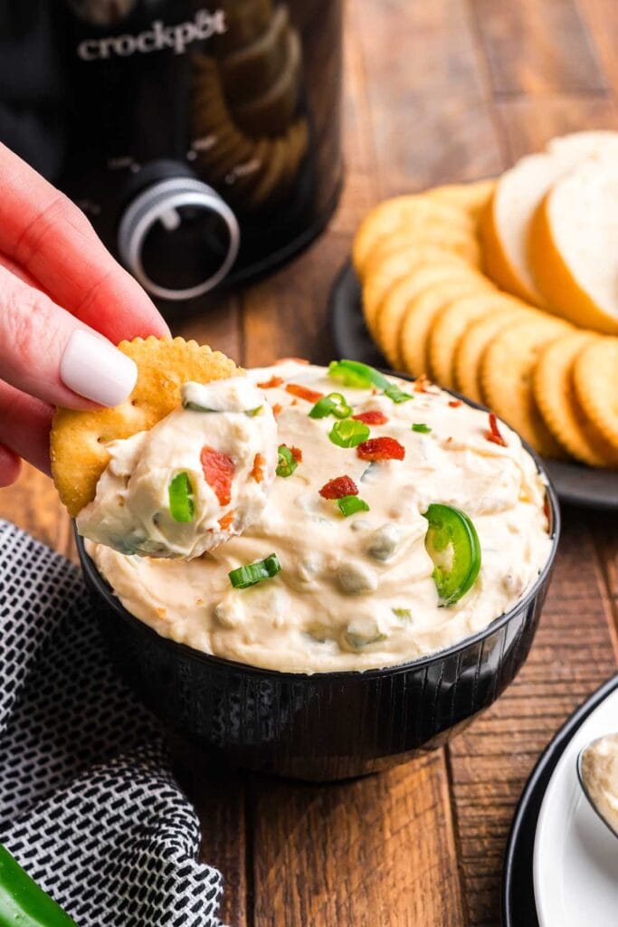 Slow cooker jalapeño popper dip in a serving bowl.