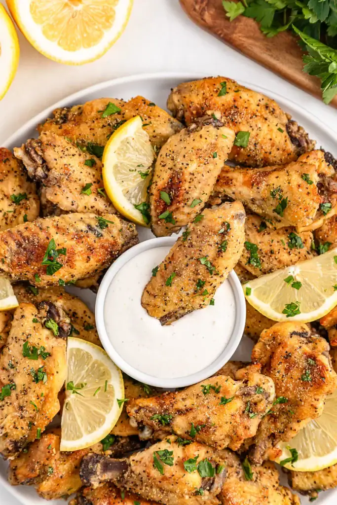 Slow cooker lemon pepper chicken wings on a plate.