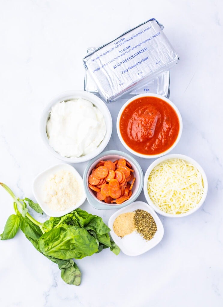 Slow Cooker Pizza Dip Ingredients on a counter.