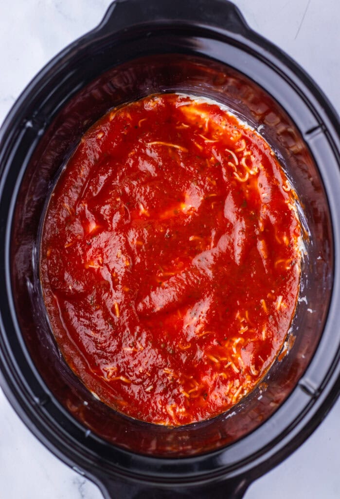 Pizza sauce spread over the cream cheese mixture.