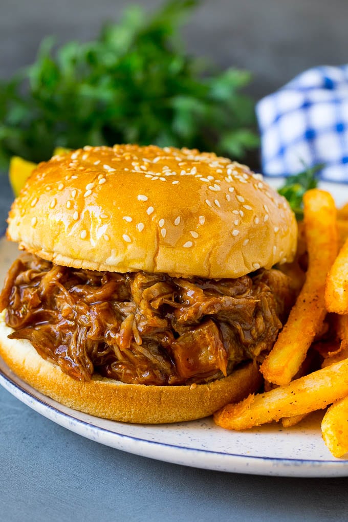 Slow cooker pulled pork sandwich on a plate.