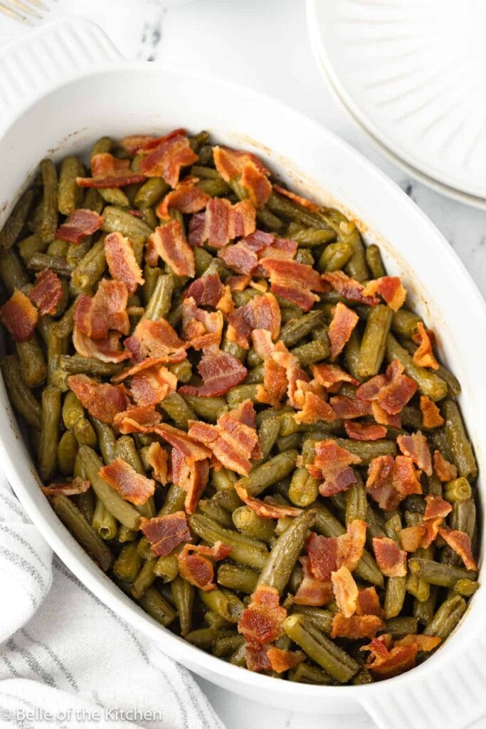 Smothered green beans in an oblong serving dish.