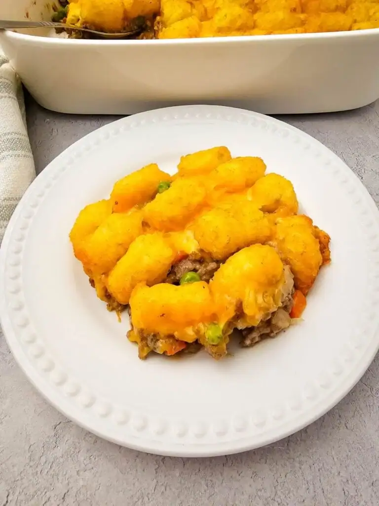 Tater tot casserole with ground beef on a plate.