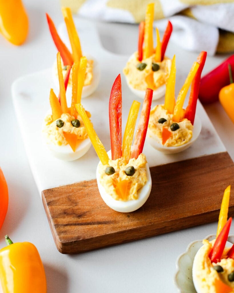 Turkey deviled eggs on a wooden board.