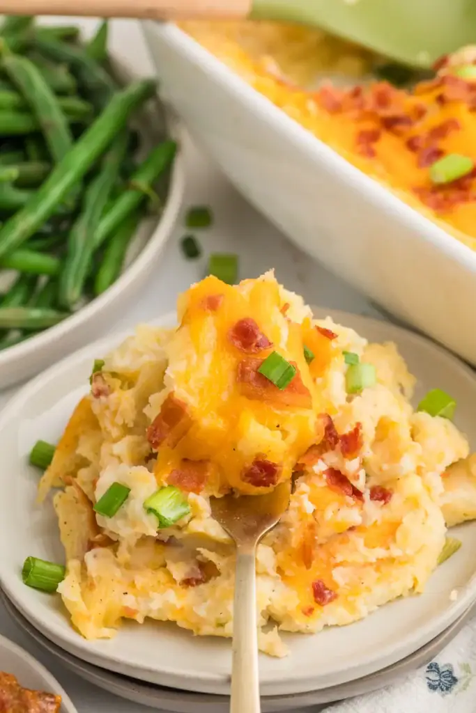 Twice-baked mashed potato casserole on a plate.