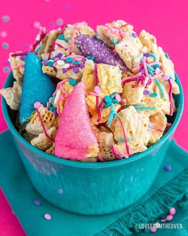 Colorful unicorn Chex mix with cereal pieces and sprinkles in a bowl.