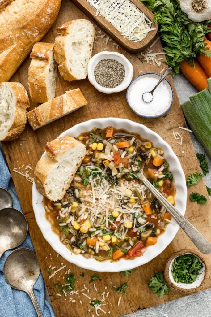 Vegetable rice soup with corn and carrots in a bowl.