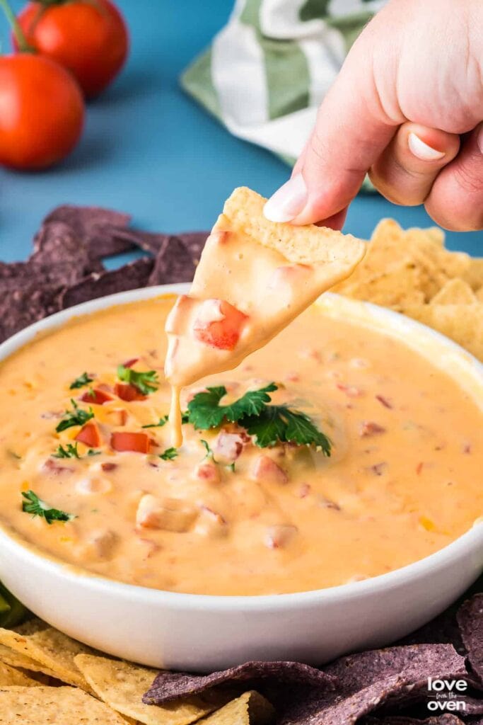 Velveeta Rotel dip with a tortilla chip for dipping.