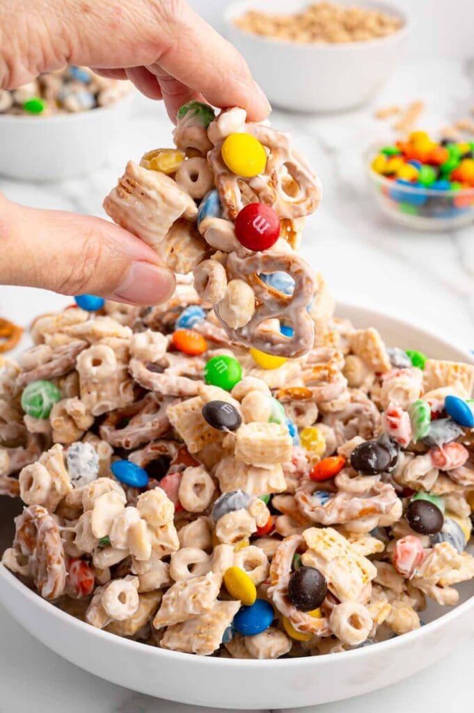 White chocolate trash snack mix with colorful candies and crunchy cereal pieces.