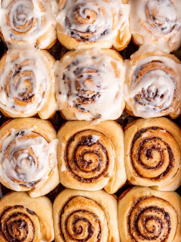 close up of snickerdoodle rolls with frosting