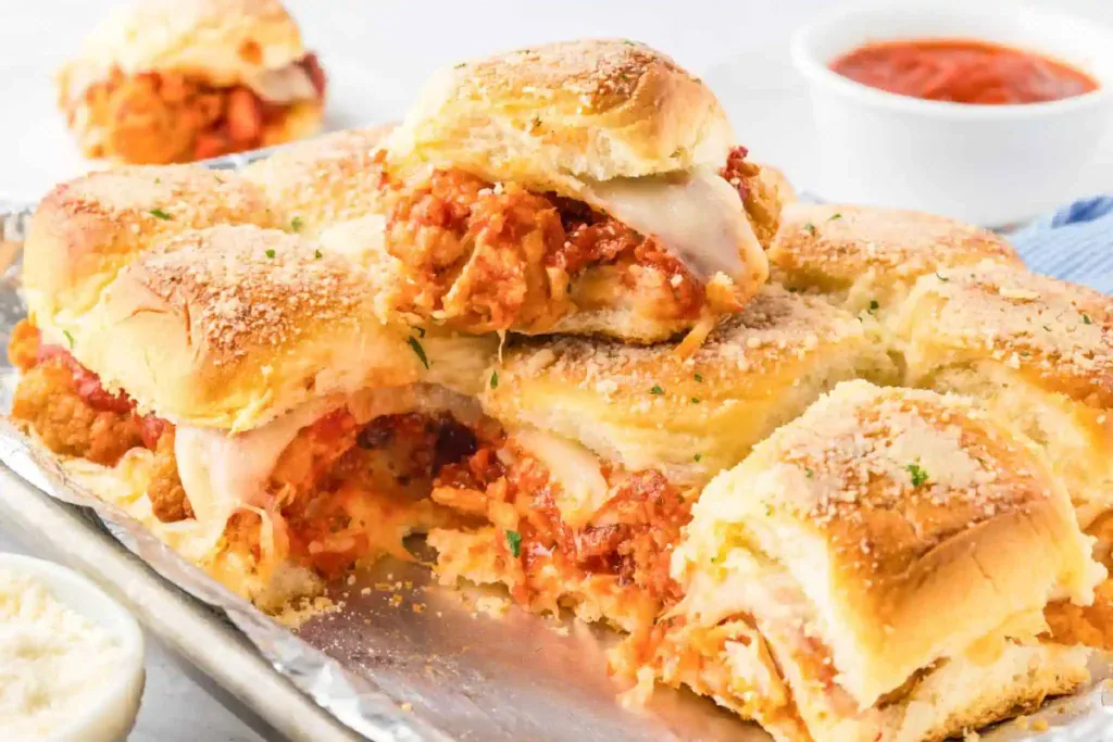 Chicken Parmesan sliders on a baking sheet.