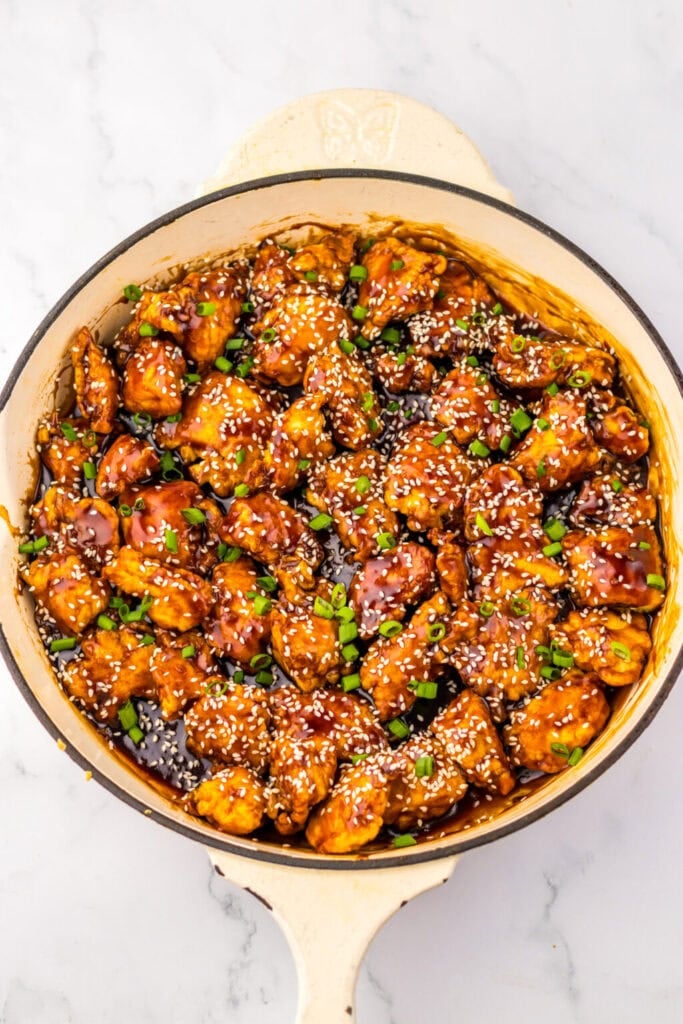 Honey sesame chicken in a skillet.