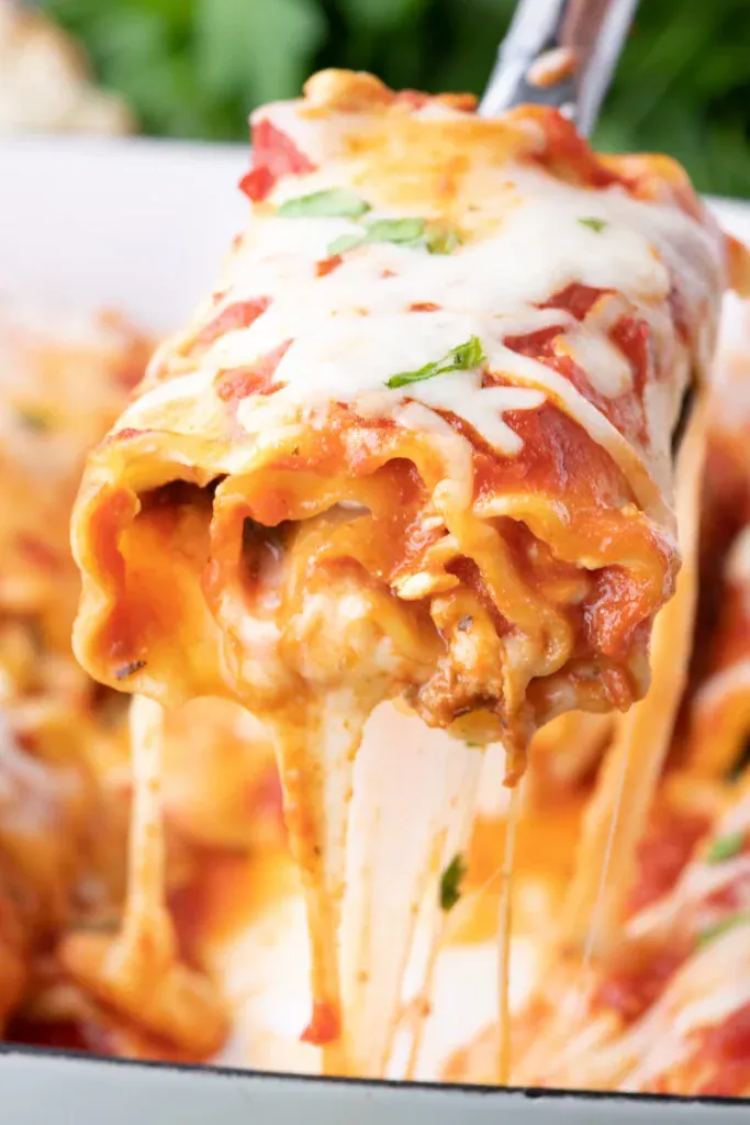 Lasagna roll ups on a spatula.