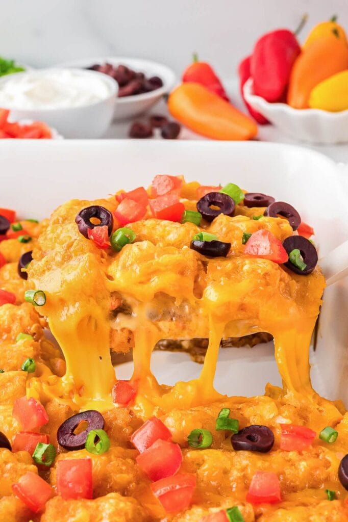 Mexican tater tot casserole with melted cheese and toppings.
