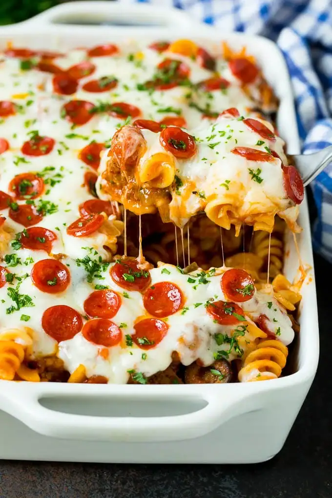 Pizza casserole with melted cheese and pepperoni in a baking dish.