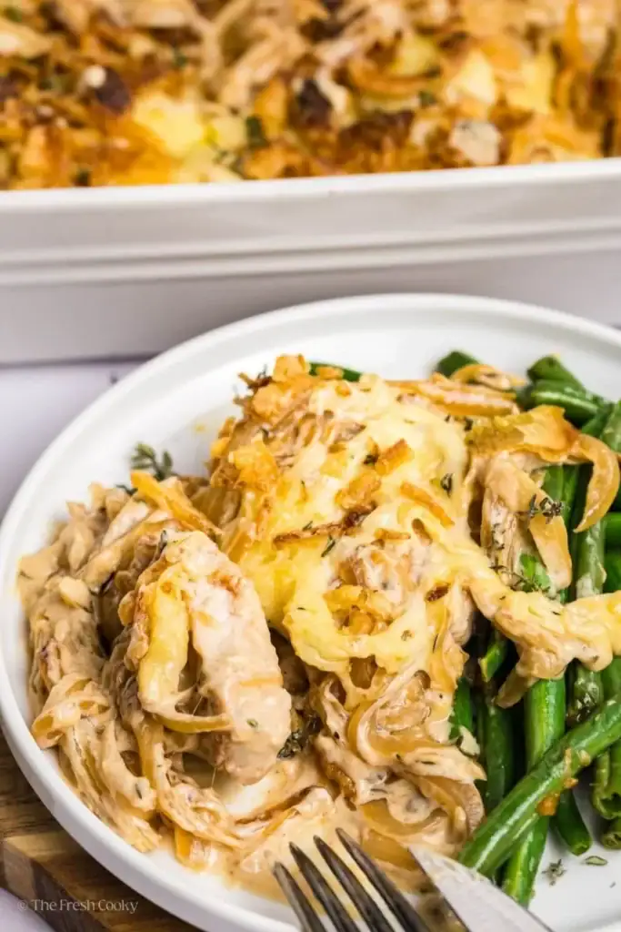 Pork chop casserole with creamy sauce and green beans on a plate.