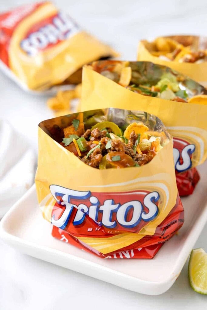 Walking tacos with seasoned beef and toppings in Fritos bags.